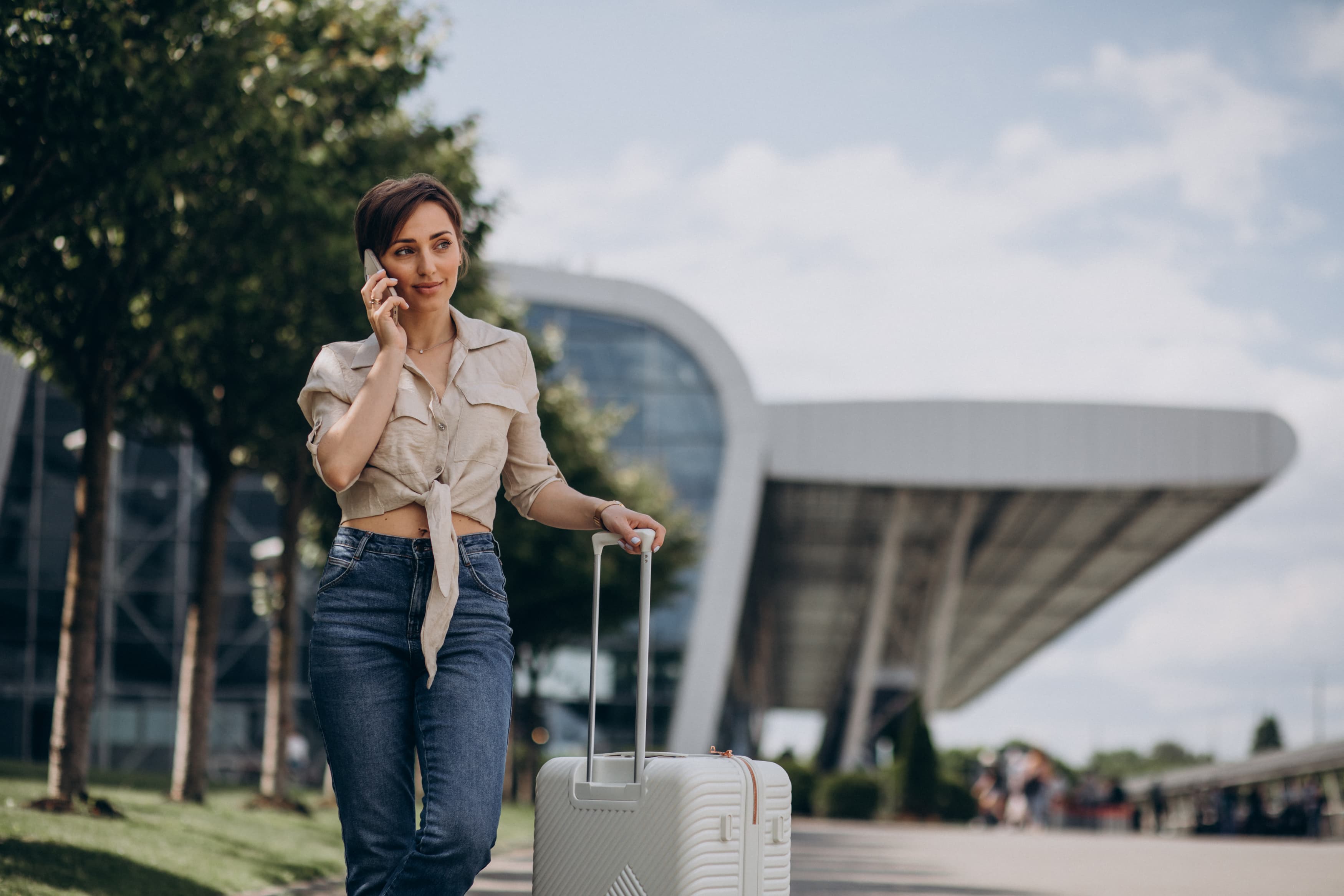 Happy traveller with luggage at Auckland Airport